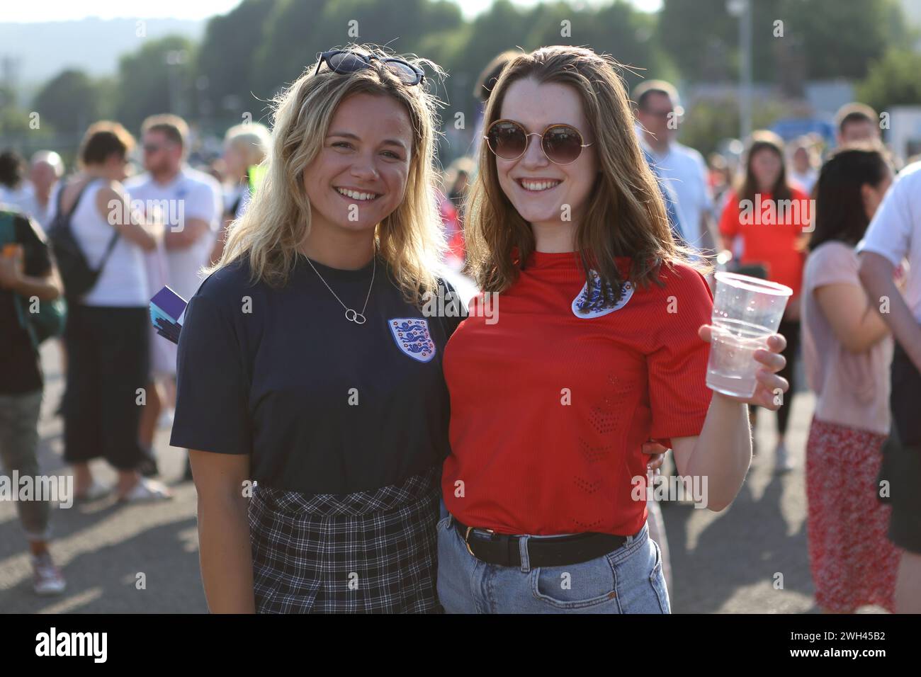 Young women England fans smile wearing England shirts England v Spain UEFA Womens Euro Brighton Community Stadium (Amex Stadium) 20 July 2022 Stock Photo