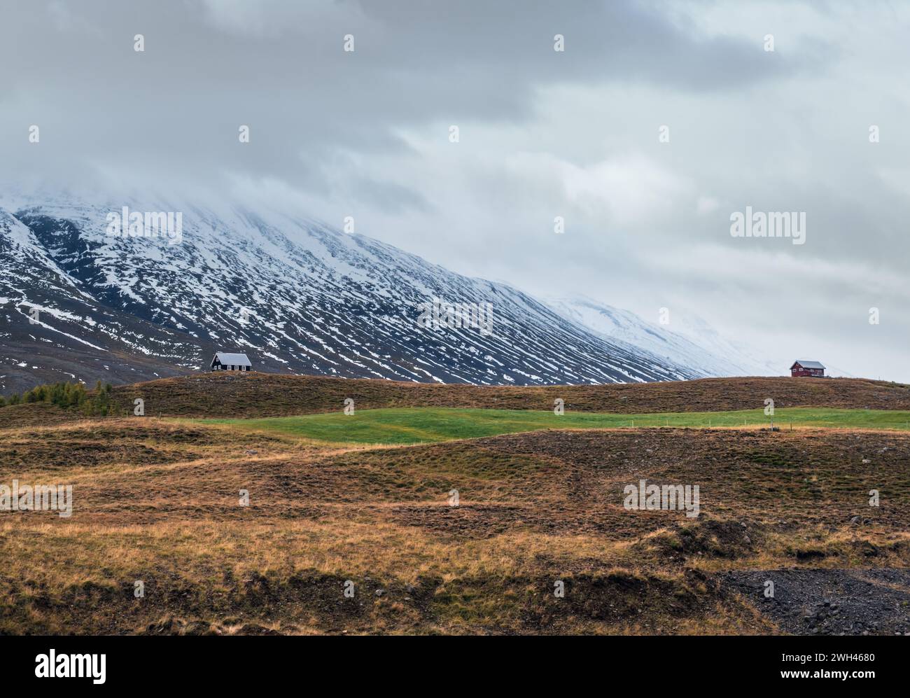 Beautiful mountain view during auto trip in Iceland. Spectacular Icelandic landscape with  scenic nature: mountains, fields, clouds, glaciers, rocks. Stock Photo