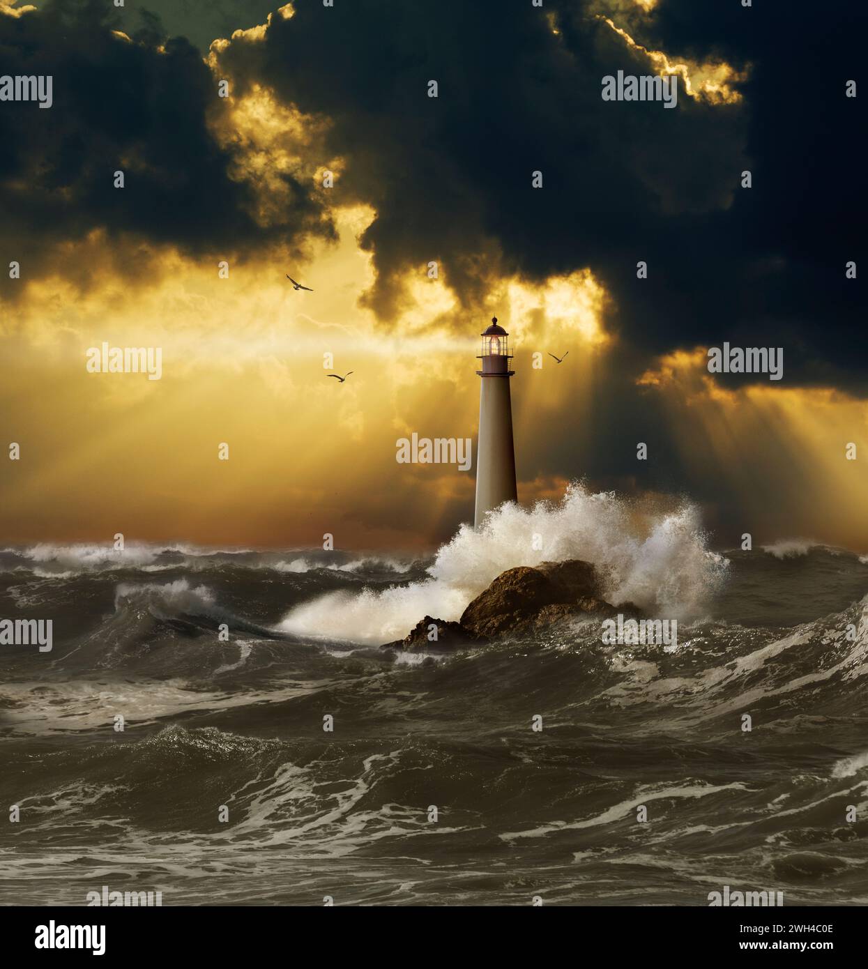 A beautiful lighthouse casts its guiding beam over storm-tossed seas under God-ray storm clouds in an image of safety, guidance, and security. Stock Photo