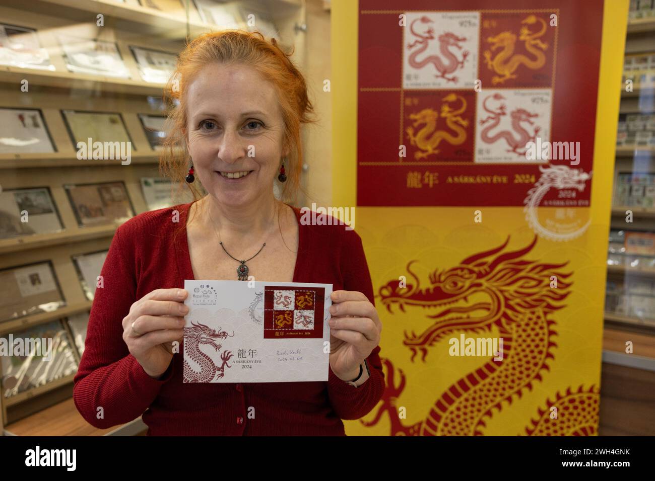 Budapest, Hungary. 7th Feb, 2024. Katalin Bodi, the Hungarian designer of the Year of the Dragon commemorative stamp recently issued by the Hungarian Post, shows a first-day cover with the stamps of the Year of the Dragon in Budapest, Hungary, on Feb. 7, 2024. Katalin Bodi said she hoped her work could help deepen the connection between Hungary and China. Credit: Attila Volgyi/Xinhua/Alamy Live News Stock Photo