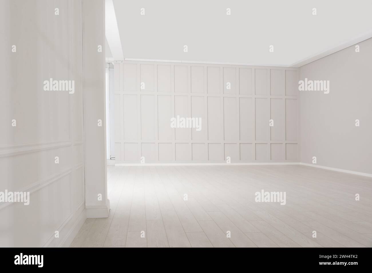 Empty room with beige walls and laminated flooring Stock Photo