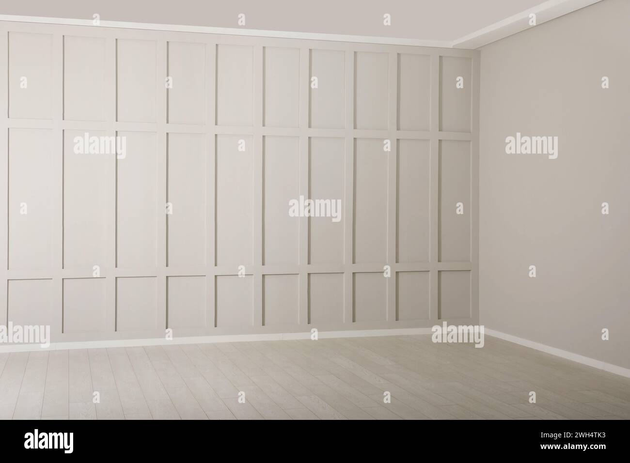 Empty room with beige walls and laminated flooring Stock Photo
