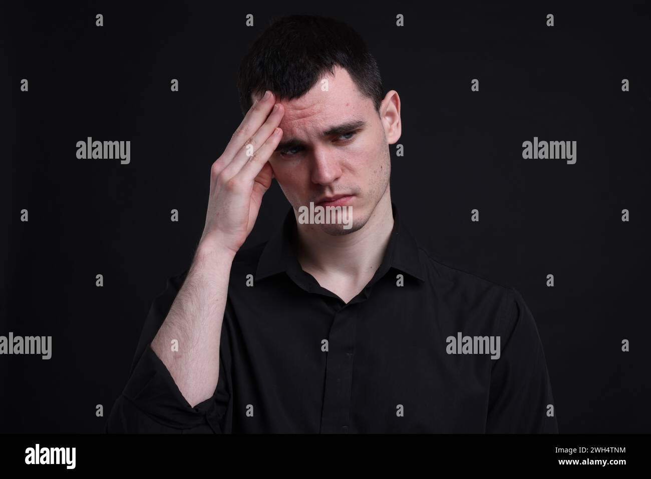 Portrait of sad man on black background Stock Photo - Alamy