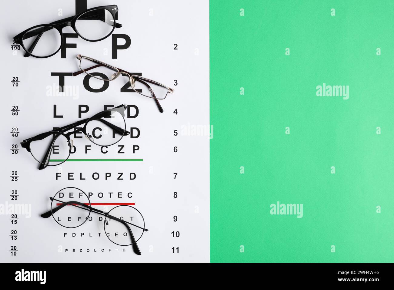 Vision Test Background Vision test chart and glasses on green background, flat lay. Space for ...