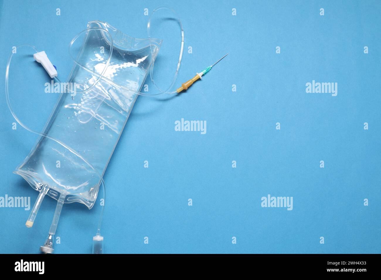 Infusion Set Background IV infusion set on light blue background, top view. Space for text ...