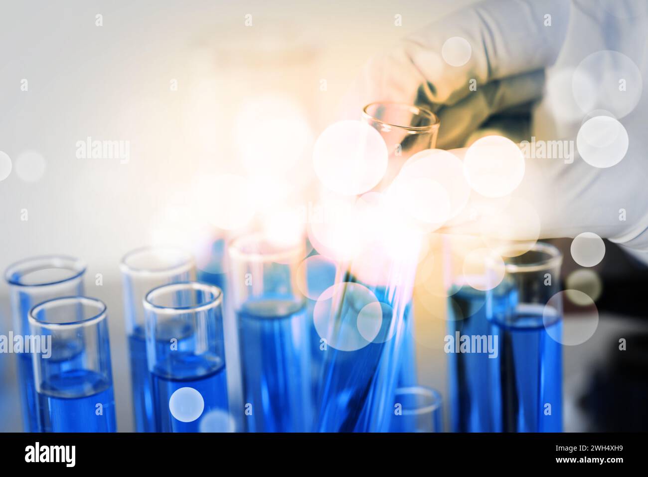 Chemist taking test tube blue hi-res stock photography and images - Alamy