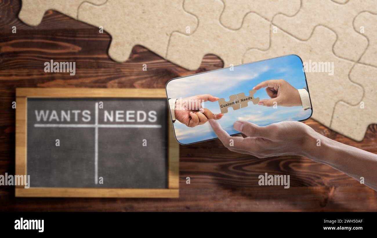 Two business hand holding pieces of a jigsaw puzzle with customer needs