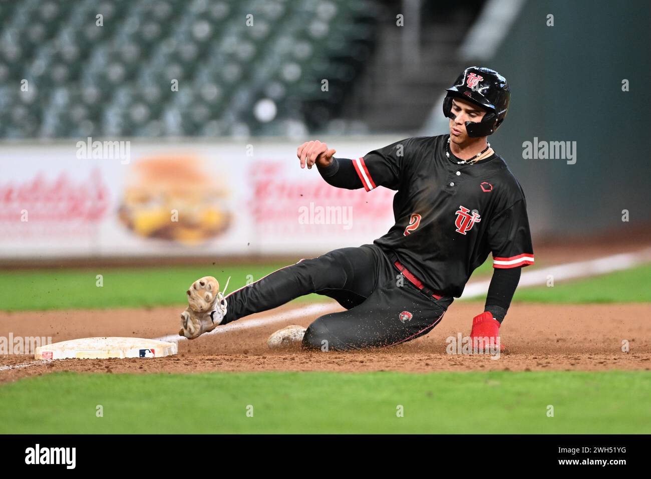 Tampa Spartans 2B Brayden Woodburn (2)  slides safely into third during the Houston Winter Invitational baseball game between Central Missouri Mules v Stock Photo