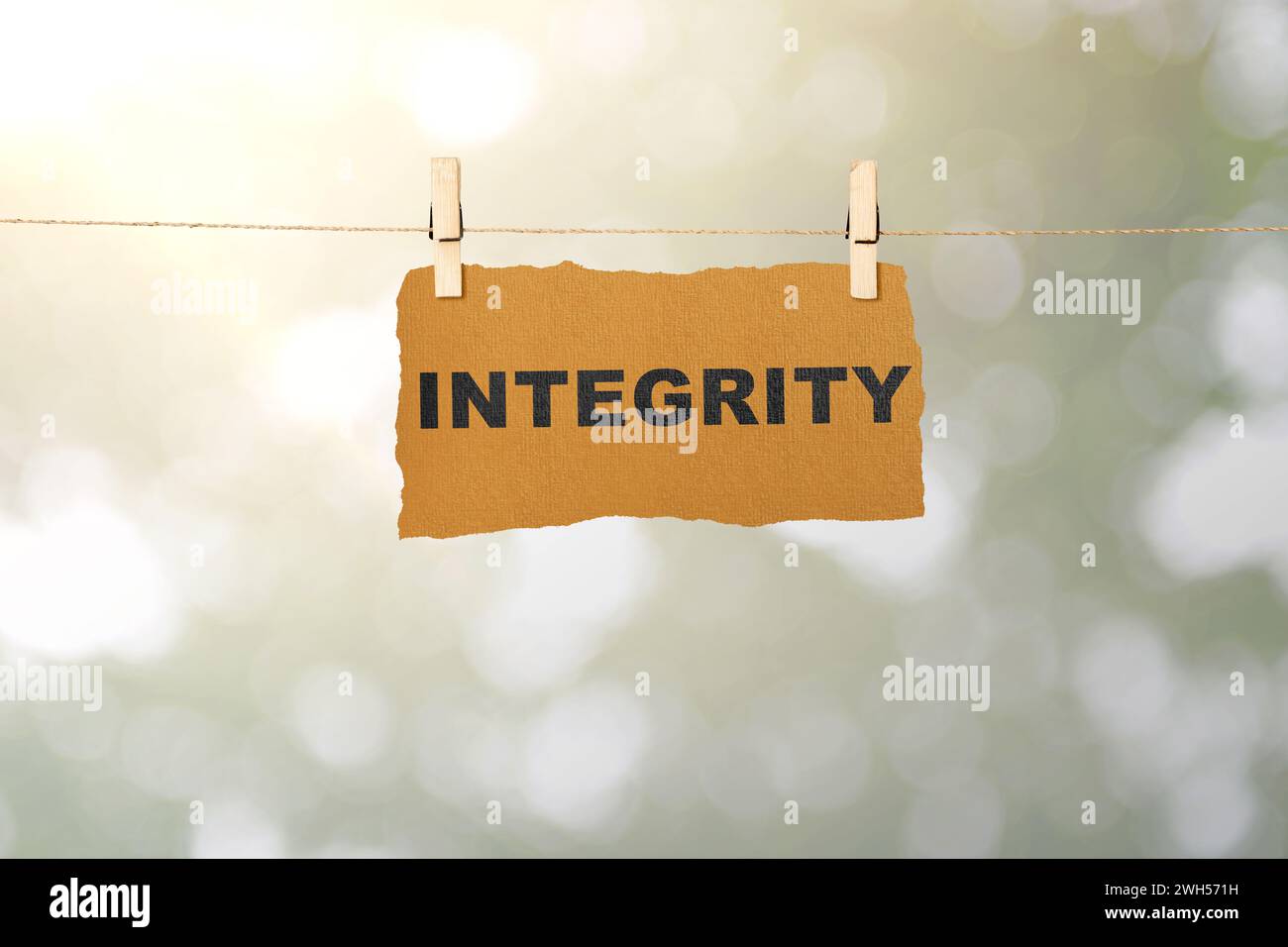 Ripped paper hanging on the rope with integrity text. Reputation ...