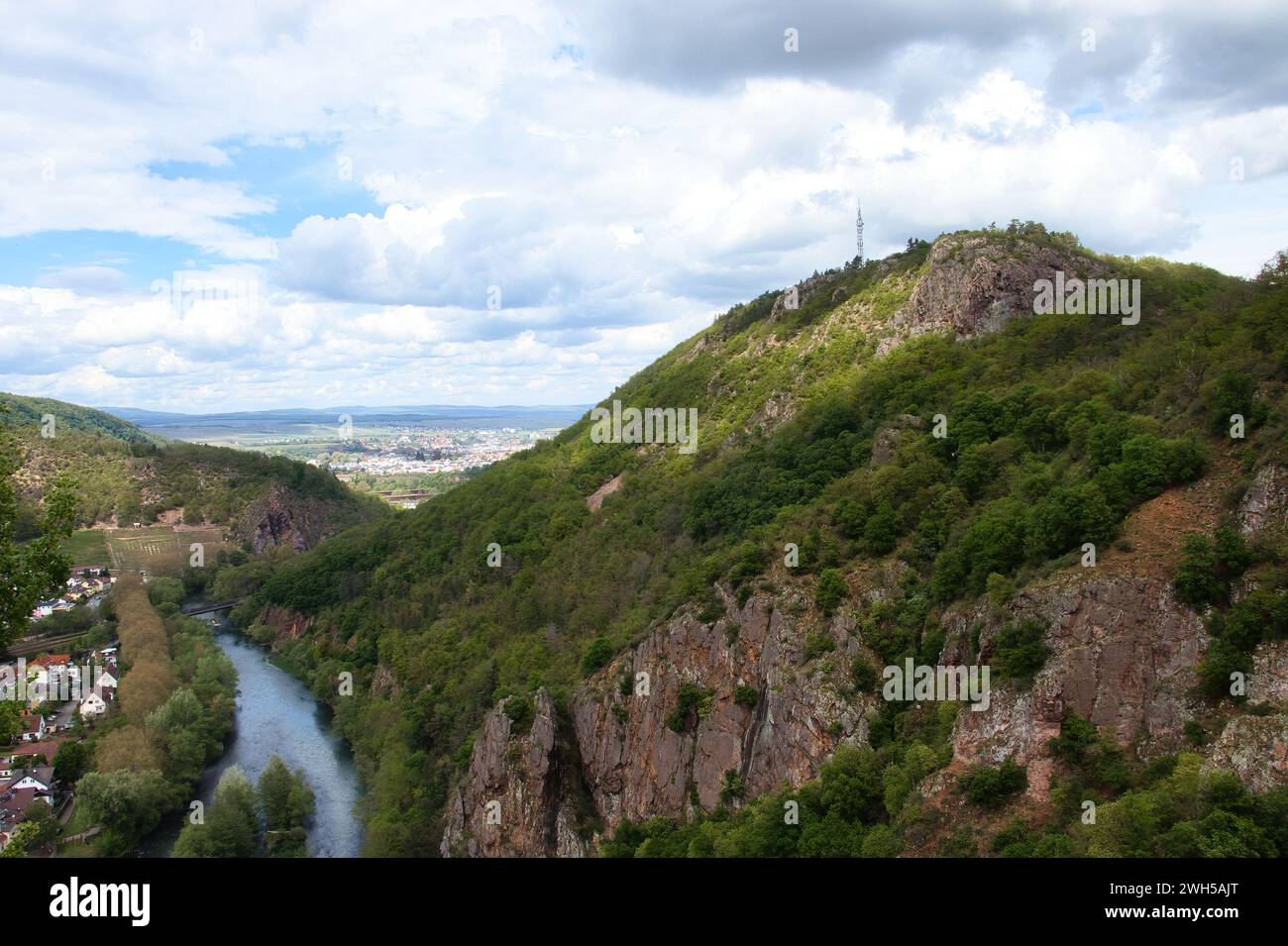 Bad Munster, Germany - May 12, 2021: Sun shining on the top of a cliff in Rotenfels above the Nahe River on a cloudy spring day in Rhineland Palatinat Stock Photo