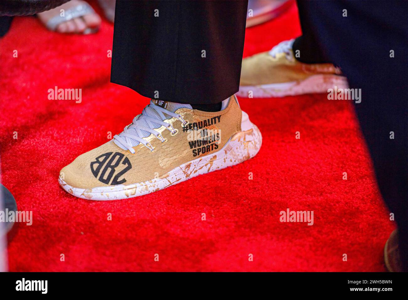 Closeup of gold shoe about equality in sports for women worn by basketball player Cheryl Miller prior to her induction at the California Hall of Fame Stock Photo