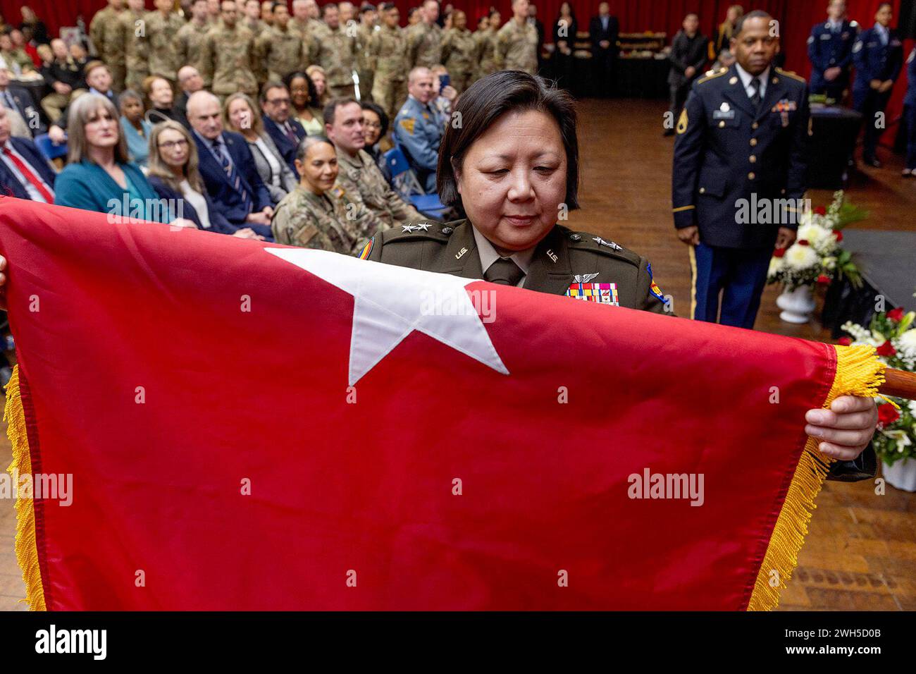 Lawrenceville, New Jersey, USA. 3rd Feb, 2024. Maj. Gen. Lisa J. Hou, D.O., The Adjutant General of New Jersey, watches as her two-star general's flag is unfurled during her promotion ceremony at National Guard Armory in Lawrenceville, New Jersey, February. 3, 2024. Hou, the 33rd Adjutant General of New Jersey, commands more than 8,400 Soldiers and Airmen of the New Jersey National Guard. As Commissioner of the New Jersey Department of Military and Veterans Affairs, Hou leads, directs, and manages the New Jersey Department of Military and Veterans Affairs in the execution of federal and Stock Photo