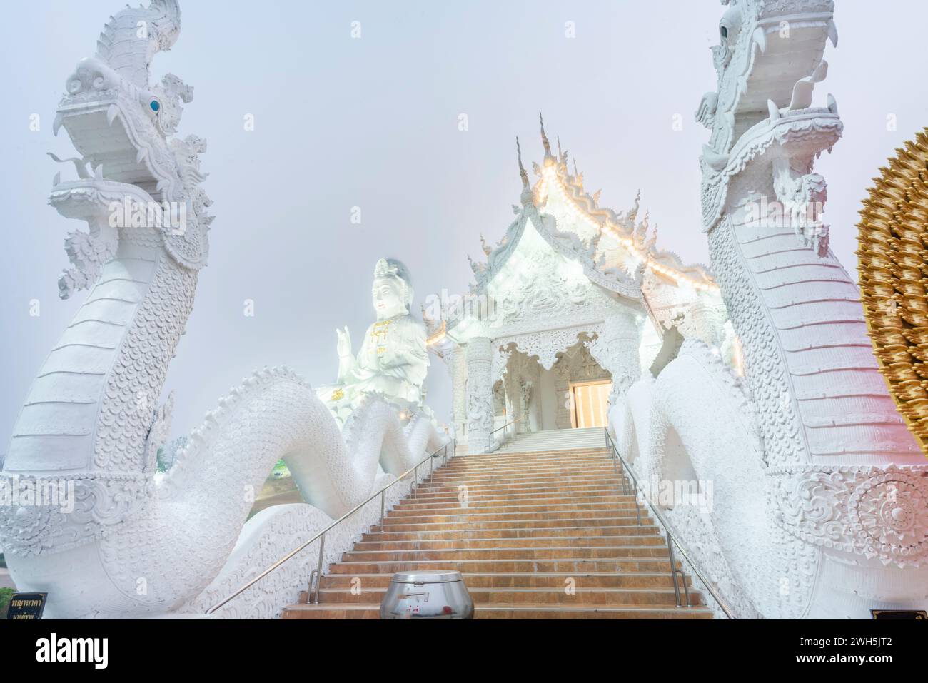 Illuminated at dusk,architecture is splendid with the mix of Chinese Guan Yin Statue, dragon stairs, white marble Buddha and Thaj style architecture.B Stock Photo