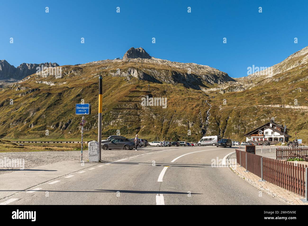 Road over the top of the Oberalp Pass, a mountain pass between the cantons of Graubuenden and Uri in the Swiss Alps Stock Photo
