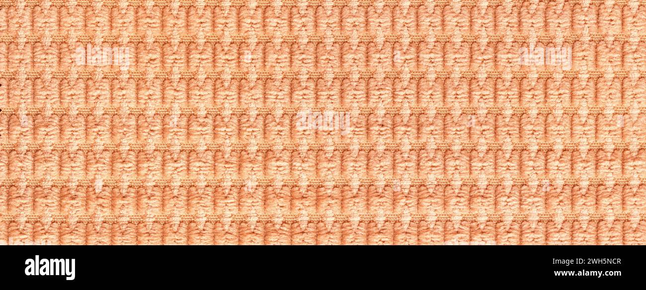 Light orange background from soft fleecy fabric close up. Texture of textiles macro. Stock Photo