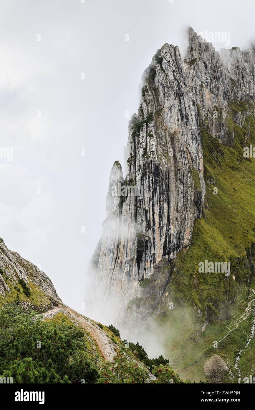 The famous Swiss Alps peak Saxer Lucke with stunning rock formation in rising mist and fog Stock Photo