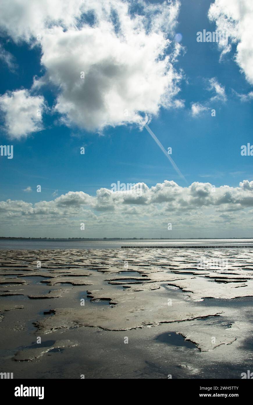 The clouds passing over the German Wadden Sea near Sehestedt on Jade Bay. Stock Photo
