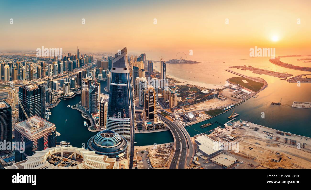 View of the Dubai skyline at sunset from above, warm earth colors in beautiful contrast to the dark teal of the water Stock Photo