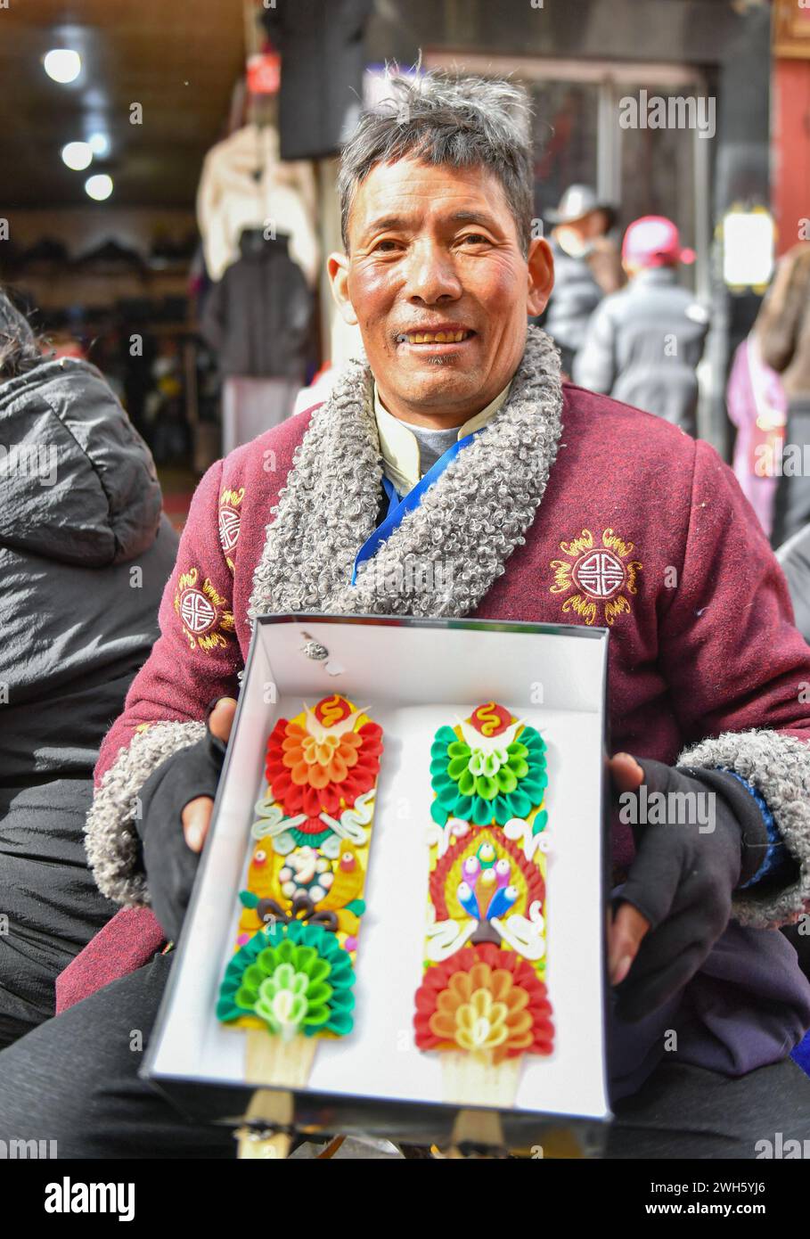 Lhasa, China's Xizang Autonomous Region. 7th Feb, 2024. A vendor shows butter sculptures in Lhasa, southwest China's Xizang Autonomous Region, Feb. 7, 2024. The Tibetan New Year coincides with the Lunar New Year, or the Spring Festival, which falls on Feb. 10 this year. As the New Year is approaching, butter sculptures handmade by local craftsmen sell quite well in Xizang. Credit: Sun Ruibo/Xinhua/Alamy Live News Stock Photo