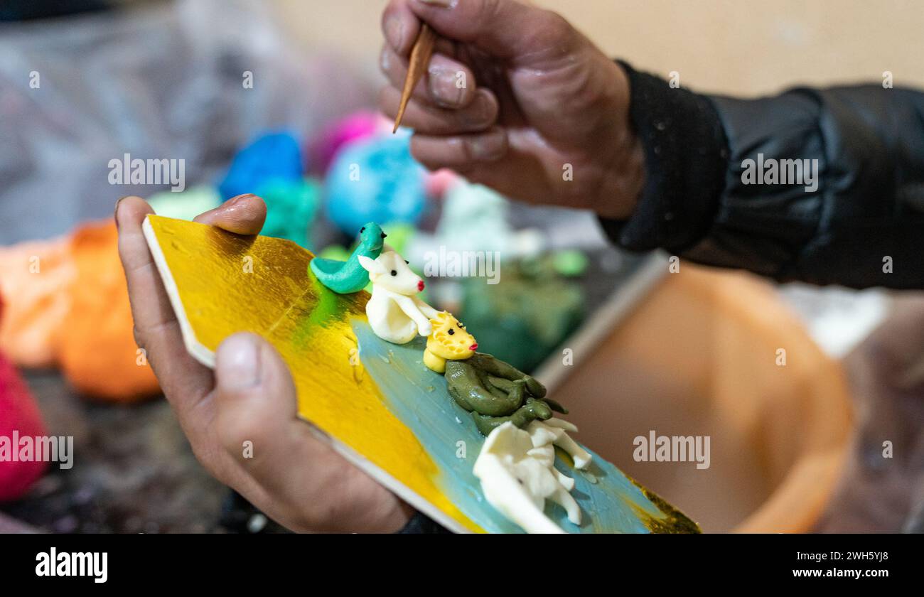 Lhasa, China's Xizang Autonomous Region. 7th Feb, 2024. A craftsman makes butter sculptures in Lhasa, southwest China's Xizang Autonomous Region, Feb. 7, 2024. The Tibetan New Year coincides with the Lunar New Year, or the Spring Festival, which falls on Feb. 10 this year. As the New Year is approaching, butter sculptures handmade by local craftsmen sell quite well in Xizang. Credit: Tenzin Nyida/Xinhua/Alamy Live News Stock Photo