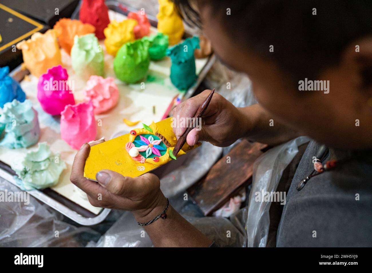 Lhasa, China's Xizang Autonomous Region. 7th Feb, 2024. A craftsman makes butter sculptures in Lhasa, southwest China's Xizang Autonomous Region, Feb. 7, 2024. The Tibetan New Year coincides with the Lunar New Year, or the Spring Festival, which falls on Feb. 10 this year. As the New Year is approaching, butter sculptures handmade by local craftsmen sell quite well in Xizang. Credit: Tenzin Nyida/Xinhua/Alamy Live News Stock Photo