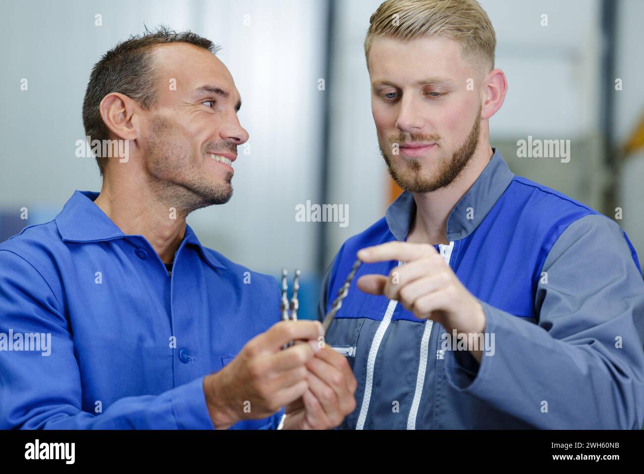 engineer with apprentice discussing tools Stock Photo