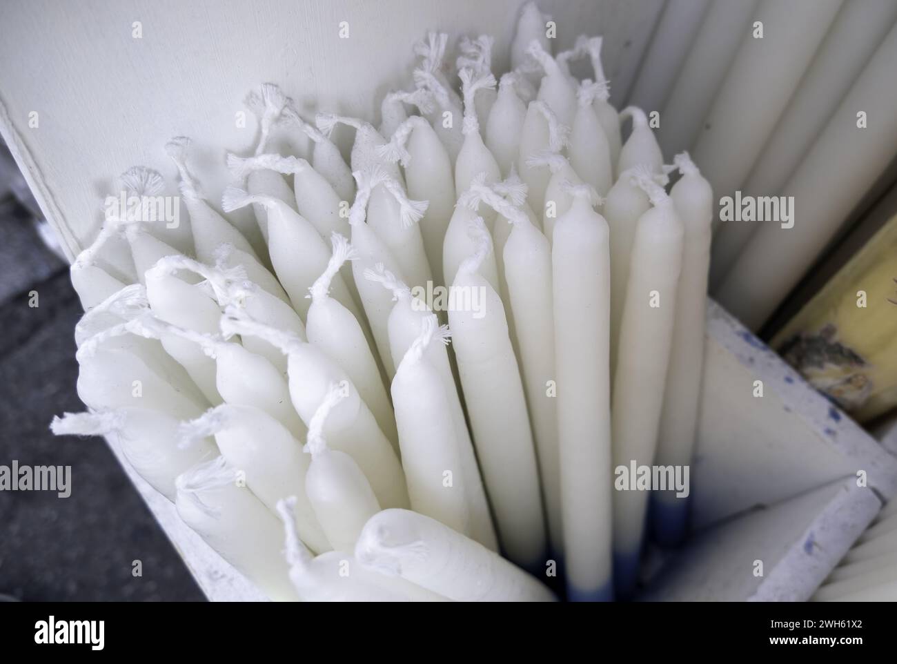 Detail of unlit white wax candle, tradition and faith Stock Photo
