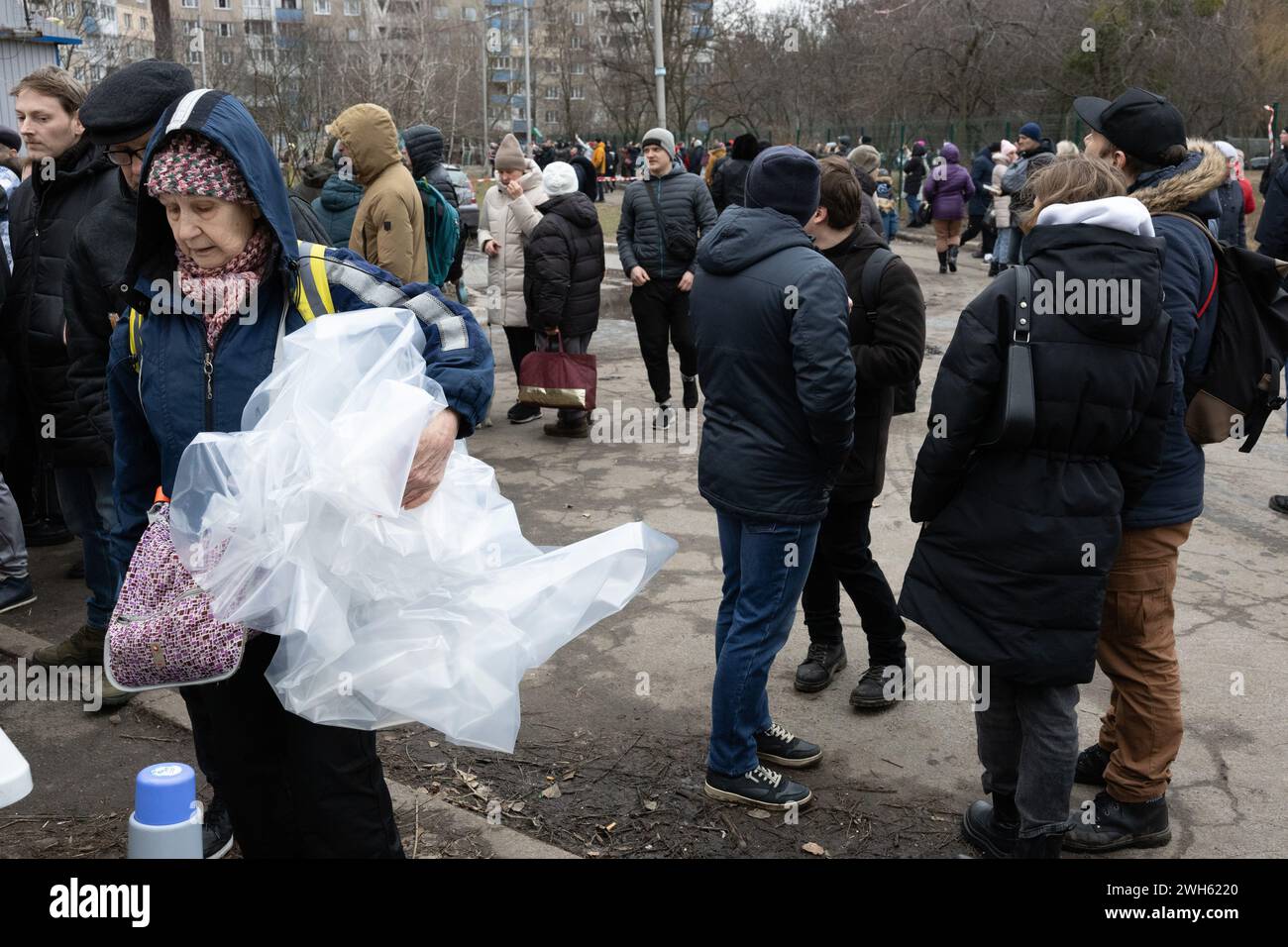 Kyiv, Ukraine. 07th Feb, 2024. A resident of a damaged apartment holds plastic film in her hands with which she will seal the broken windows in the building damaged by falling debris of a shot-down Russian missile following a missile strike in Kyiv. At least four people were killed and 19 others were injured after a Russian shelling hit Kyiv, according to Ukrainian Emergency Services. Credit: SOPA Images Limited/Alamy Live News Stock Photo