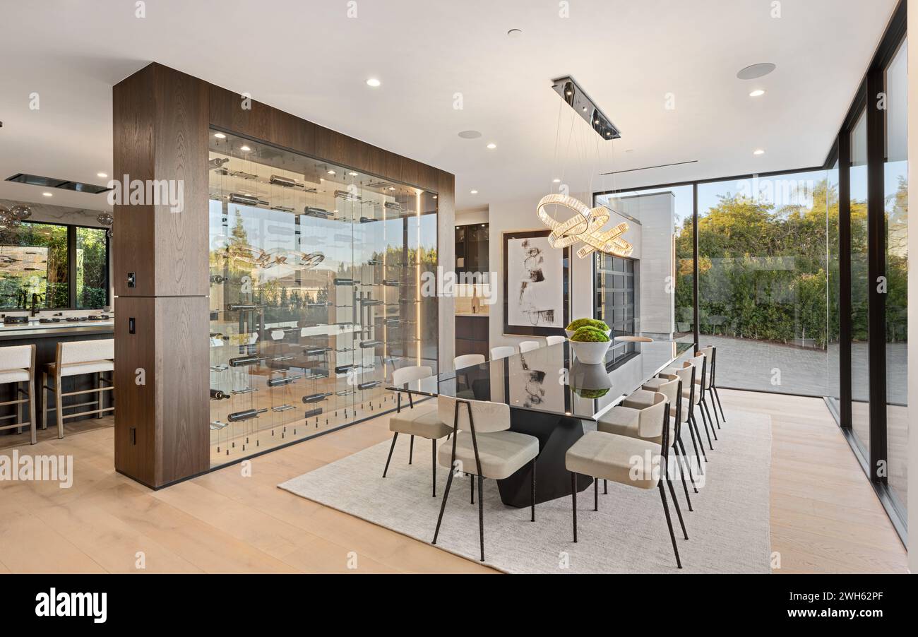 A spacious dining area with hardwood floors and expansive floor-to ...