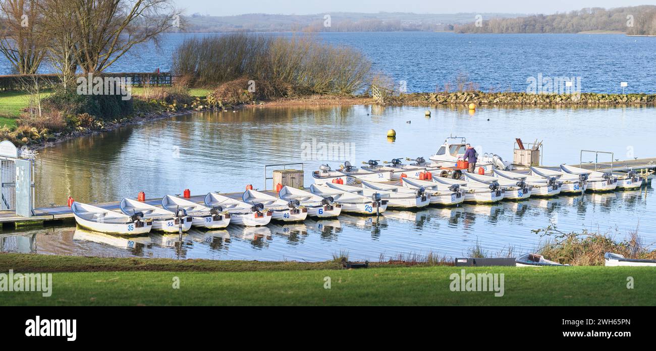 Boat Rowing Rutland Small motor boats, used by fishermen, lined up in a mini harbour at the ...