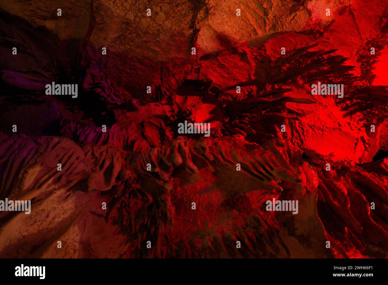 Journey through a vibrant cave adorned with colorful walls, stalactites ...