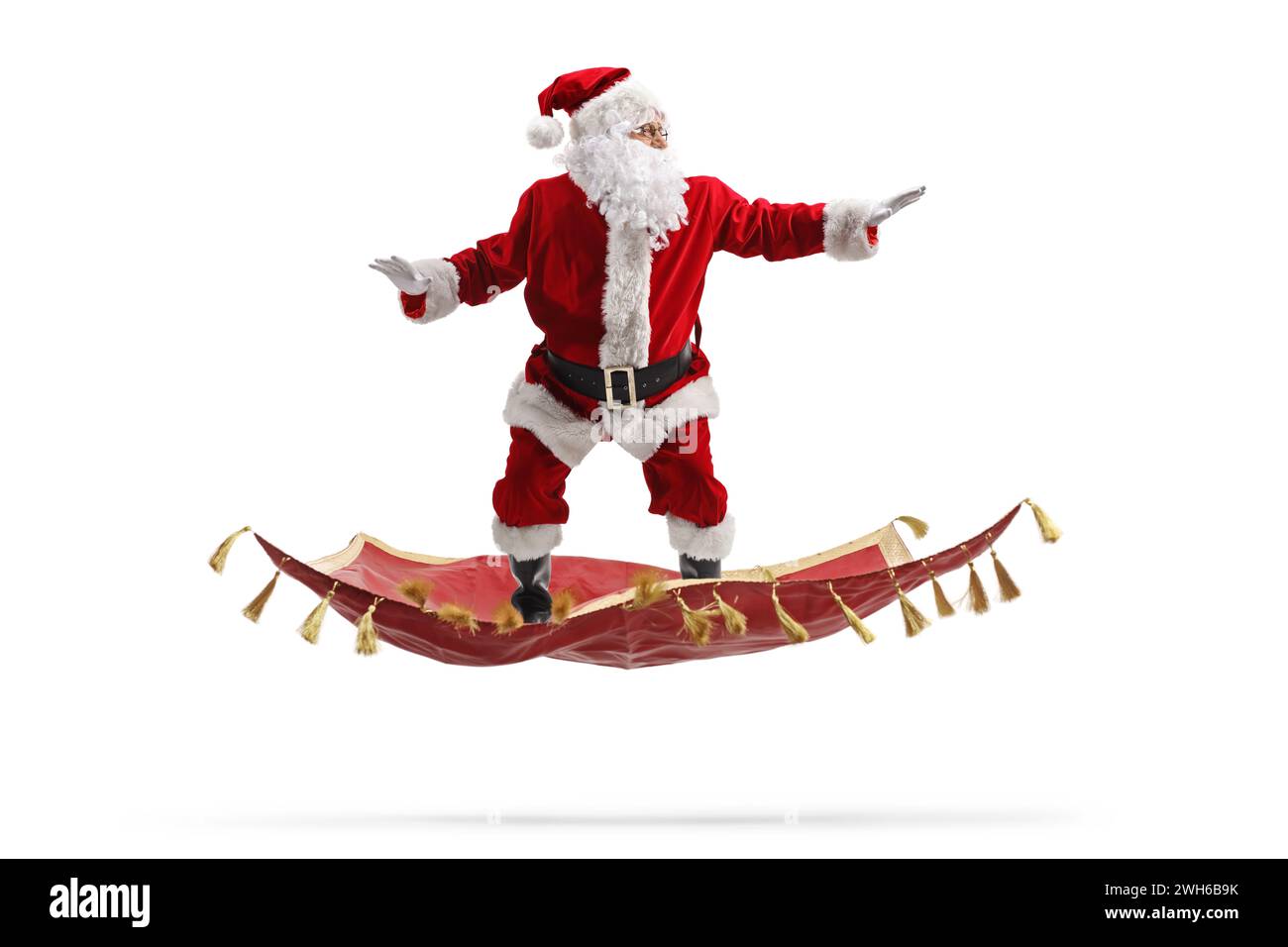 Santa claus flying on a magic carpet isolated on white background Stock Photo