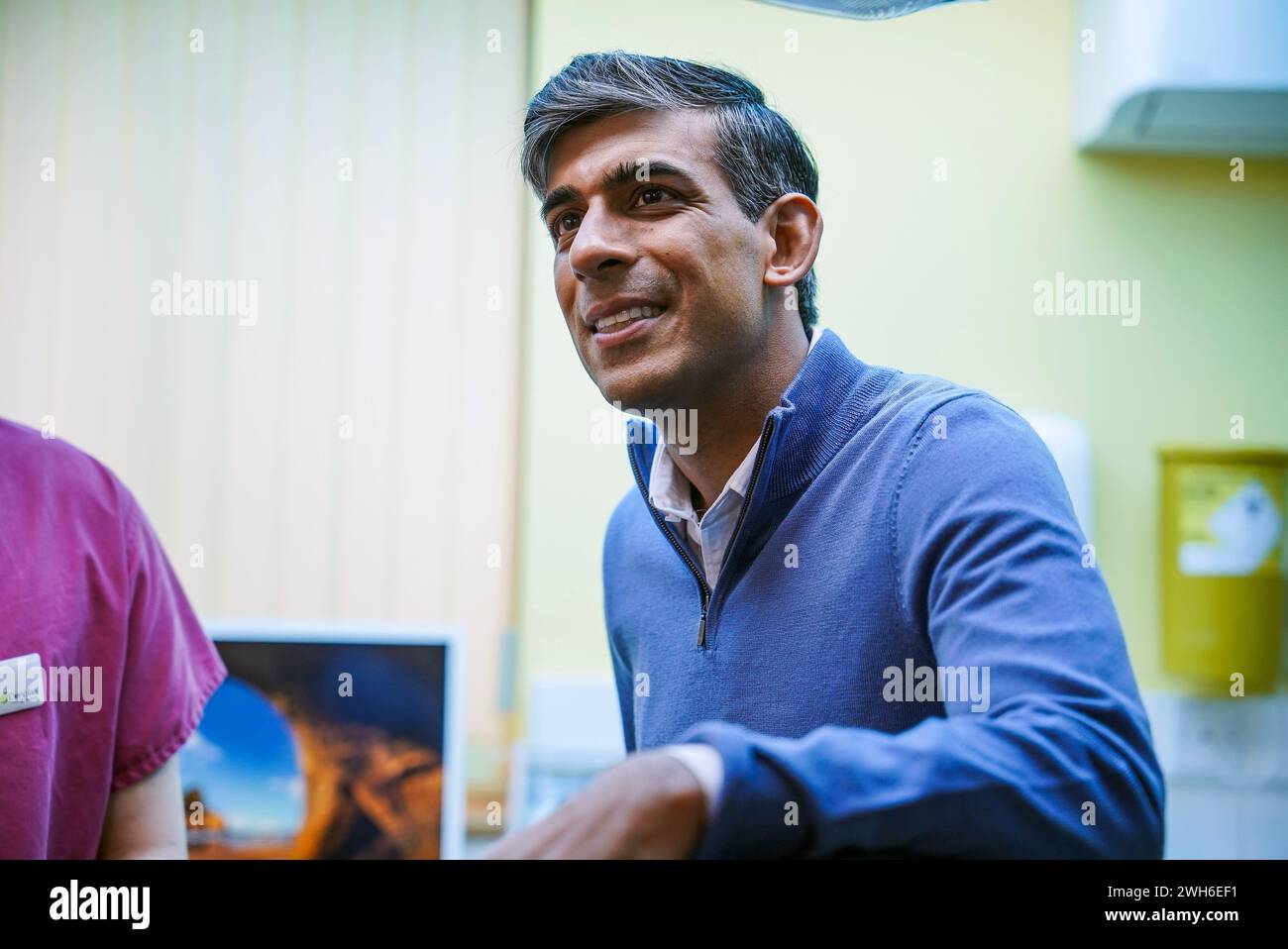Prime Minister Rishi Sunak talking to staff and patients during a visit