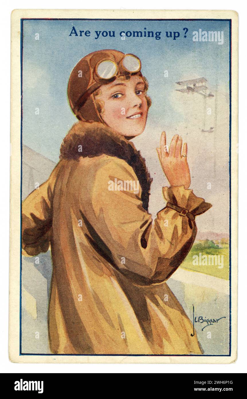 Original 1920's era colour illustrated postcard of emancipated young woman - female pilot / aviator or passenger, wearing a leather helmet, fur-lined  flying jacket, and goggles, waving goodby, about to board a biplane, 'are you coming up'. Illustrated by J.L. Biggar. dated / posted 12 October 1922 Stock Photo