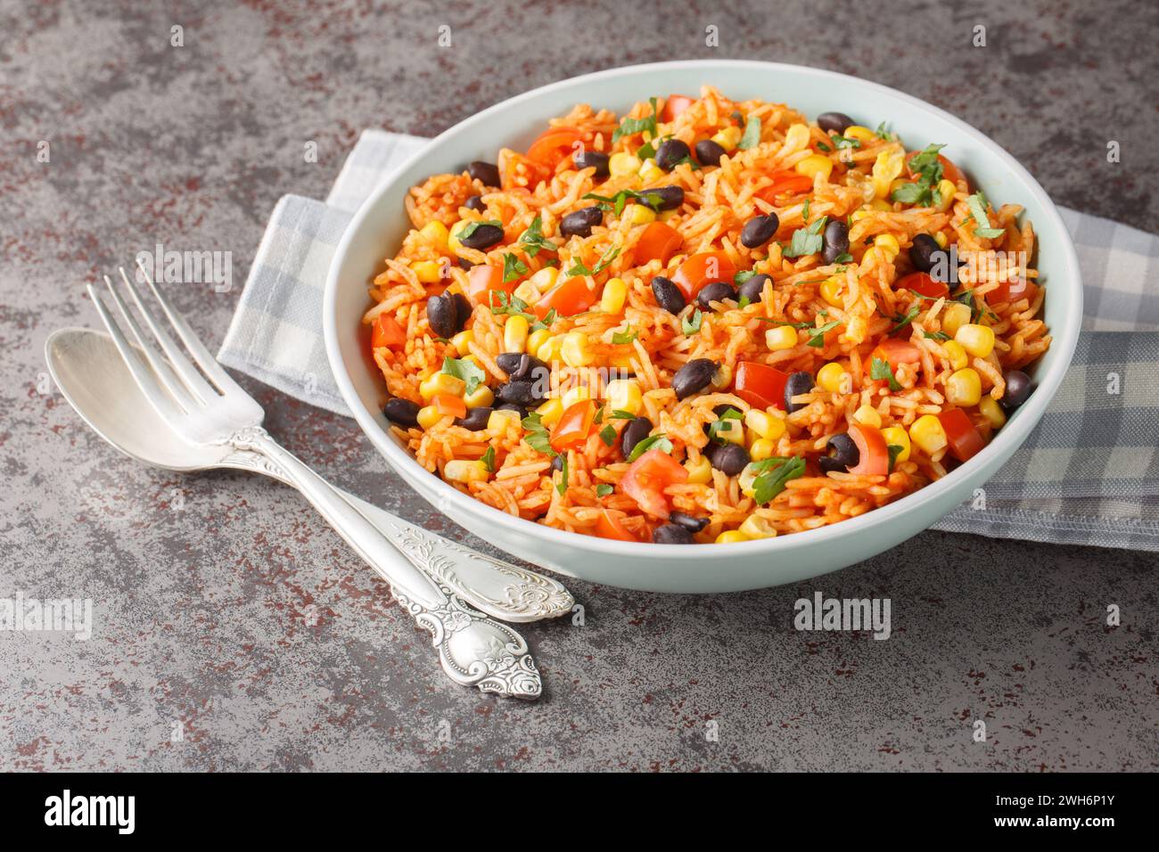 Spanish, Mexican tomato spicy rice with beans close-up in a bowl on the table. Horizontal Stock Photo