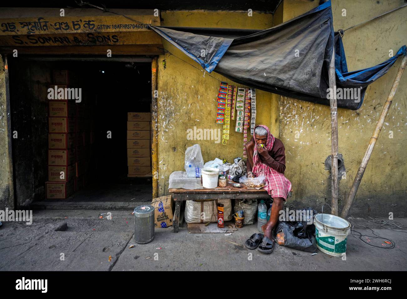 A roadside vendor drinks tea in a market in Guwahati, India, Thursday