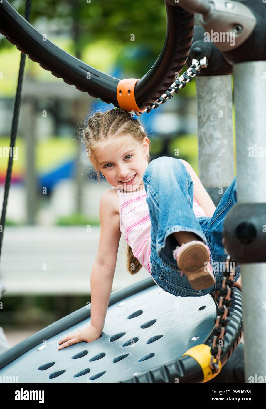 Happy little girl playing at the playground outdoor Stock Photo - Alamy
