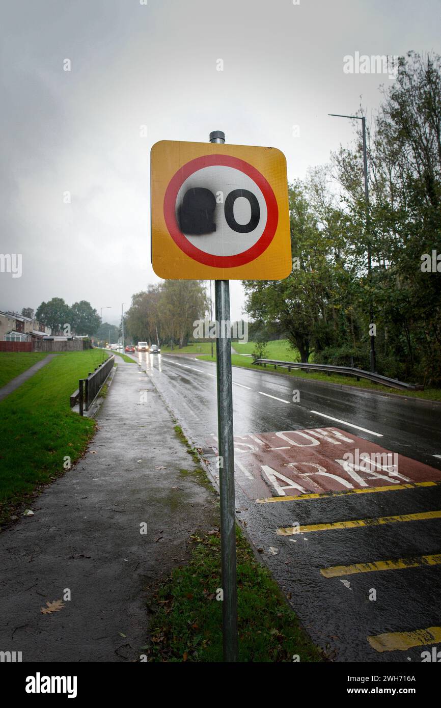 A 20mph road sign that has been defaced in Cwmbran South Wales UK. People are protesting about the new 20mph speed limit in Wales. The Welsh Goverment Stock Photo