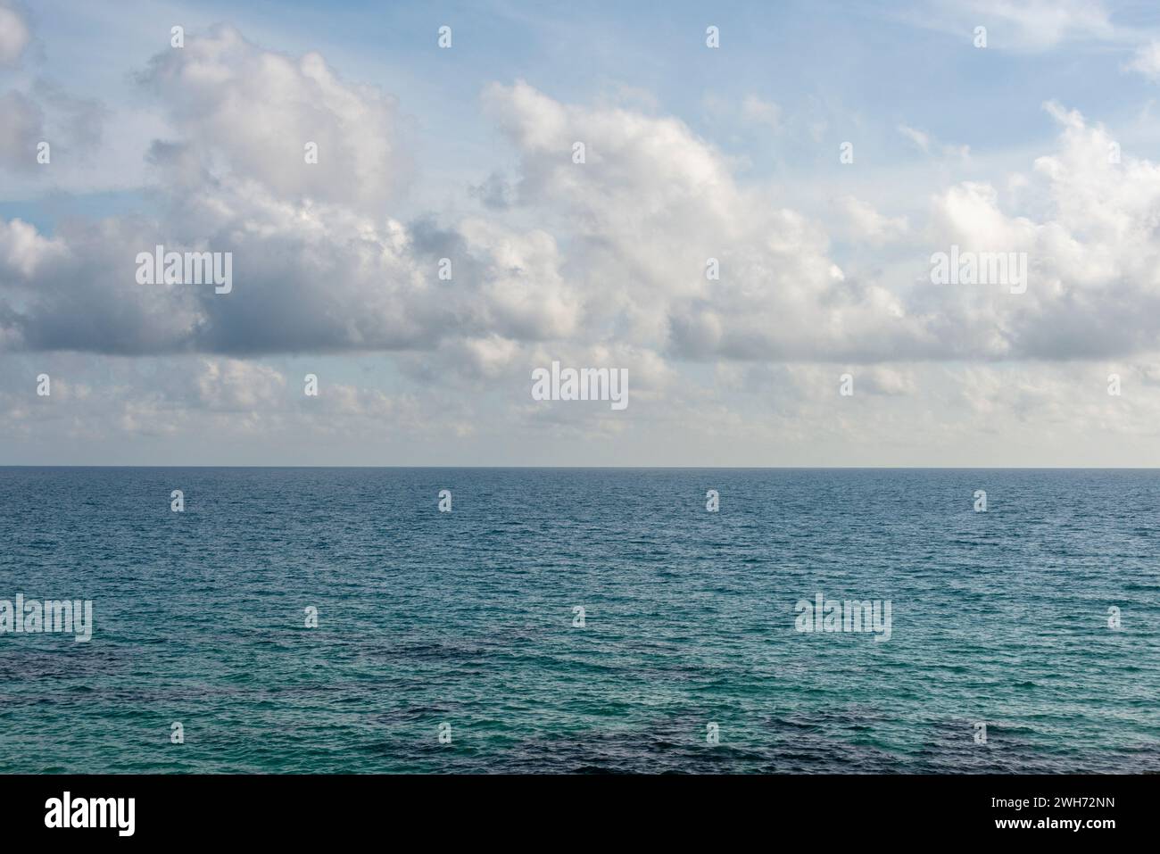 white clouds above a blue sea Stock Photo