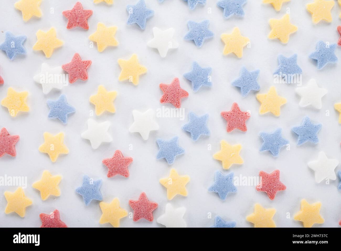 Colorful sugar sprinkles on white background Stock Photo