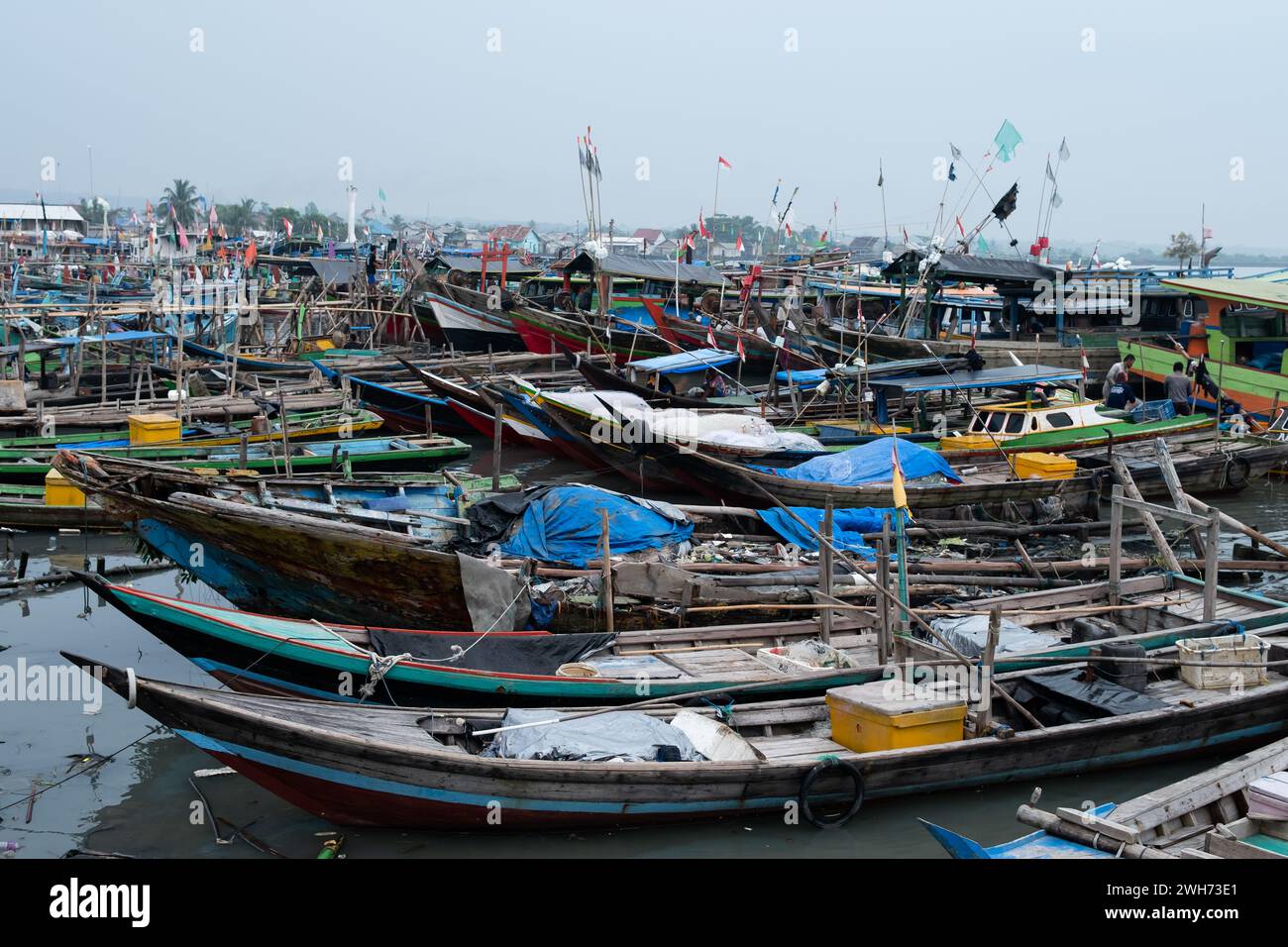 Rows of fishing net boats parked at a fish auction in Indonesia Stock Photo