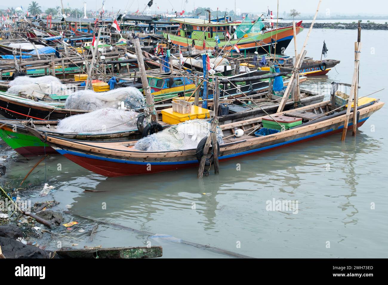 Rows of fishing net boats parked at a fish auction in Indonesia Stock Photo