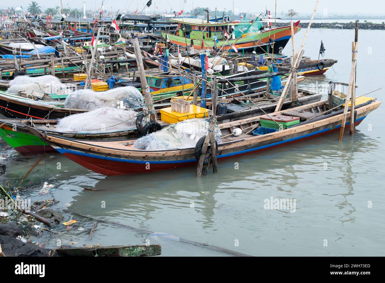 Rows of fishing net boats parked at a fish auction in Indonesia Stock ...