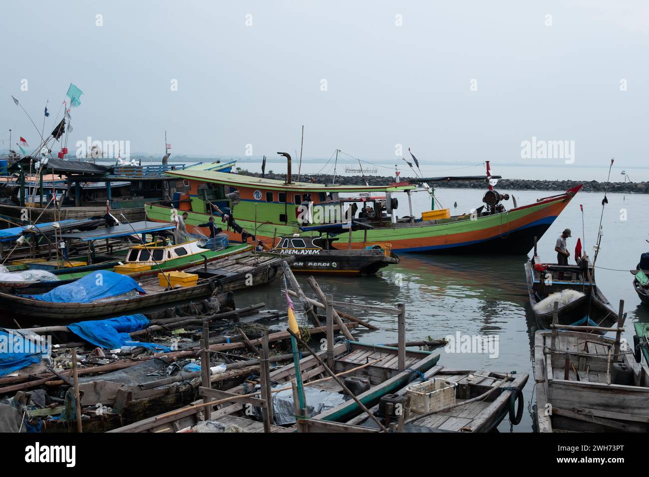 Rows of fishing net boats parked at a fish auction in Indonesia Stock Photo