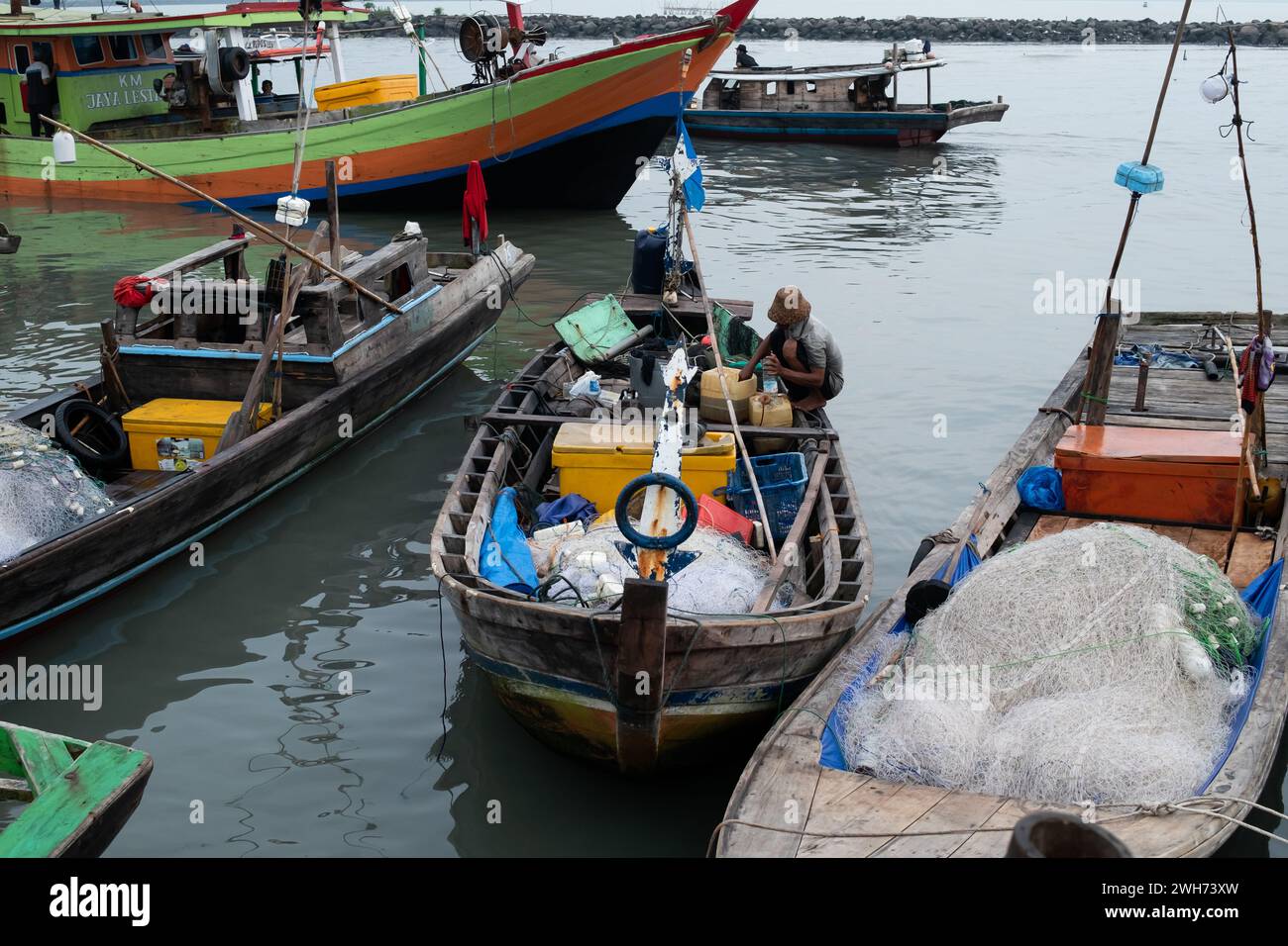 Rows of fishing net boats parked at a fish auction in Indonesia Stock ...