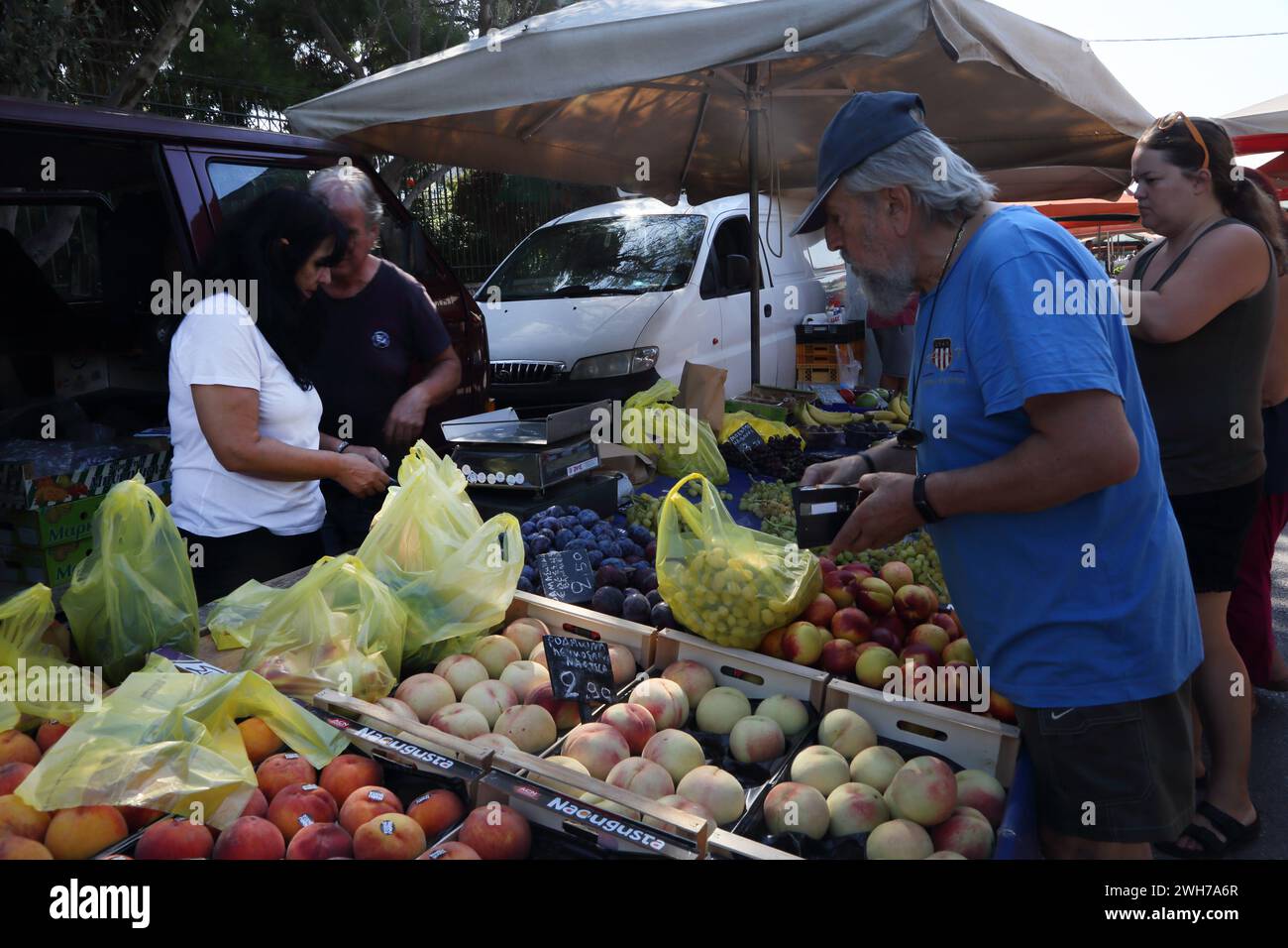 Bagging up Fruit for Customer at Market Vouliagmeni Athens Attica Greece Stock Photo