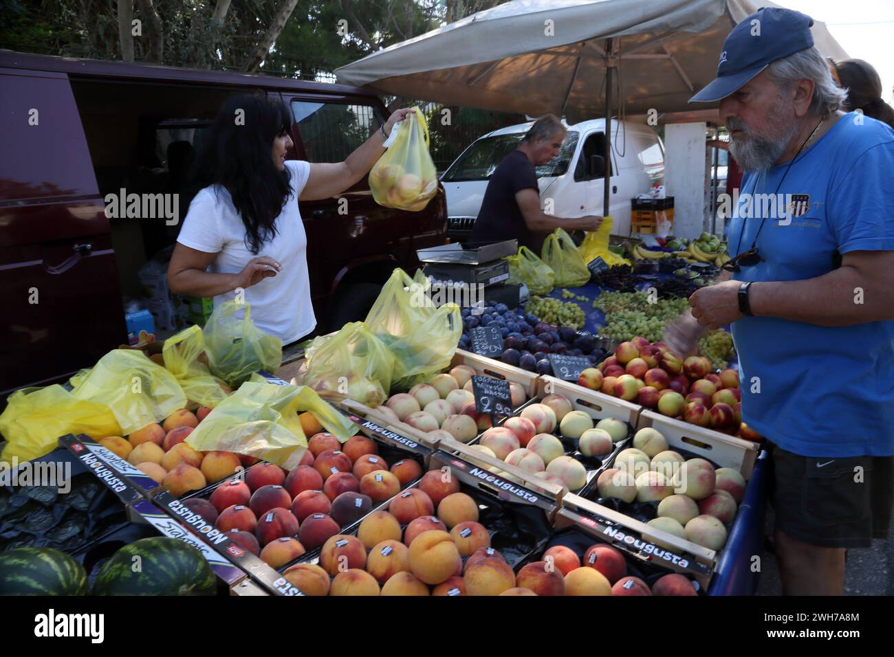Bagging up Fruit for Customer at Market Vouliagmeni Athens Attica Greece Stock Photo