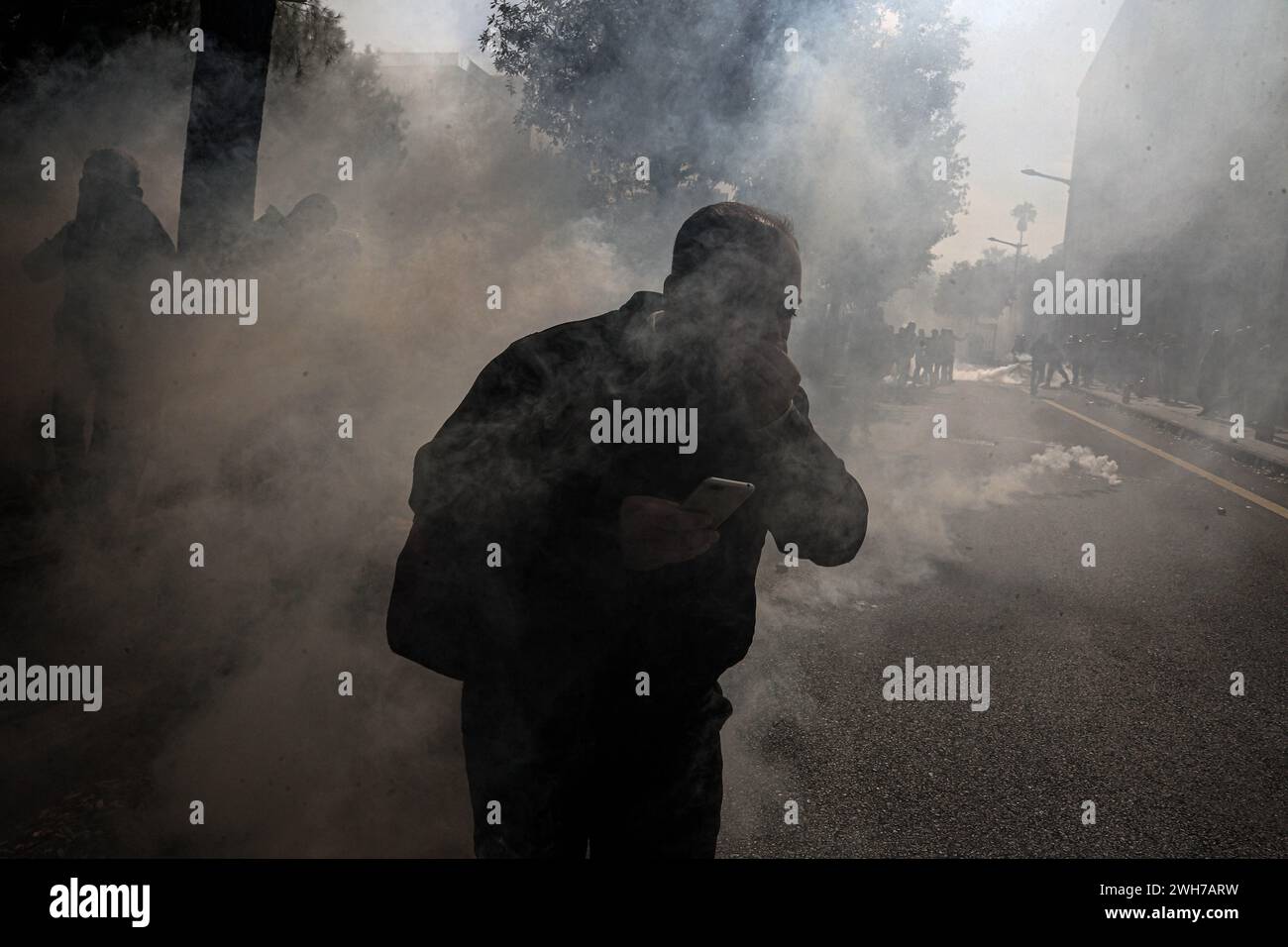 Beirut, Lebanon. 08th Feb, 2024. A retired Lebanese soldier is engulfed in smoke of tear gas bombs fired at them by riot police securing the premises of the Grand Serail, the headquarters of the Lebanese government in Beirut. Credit: Marwan Naamani/dpa/Alamy Live News Stock Photo