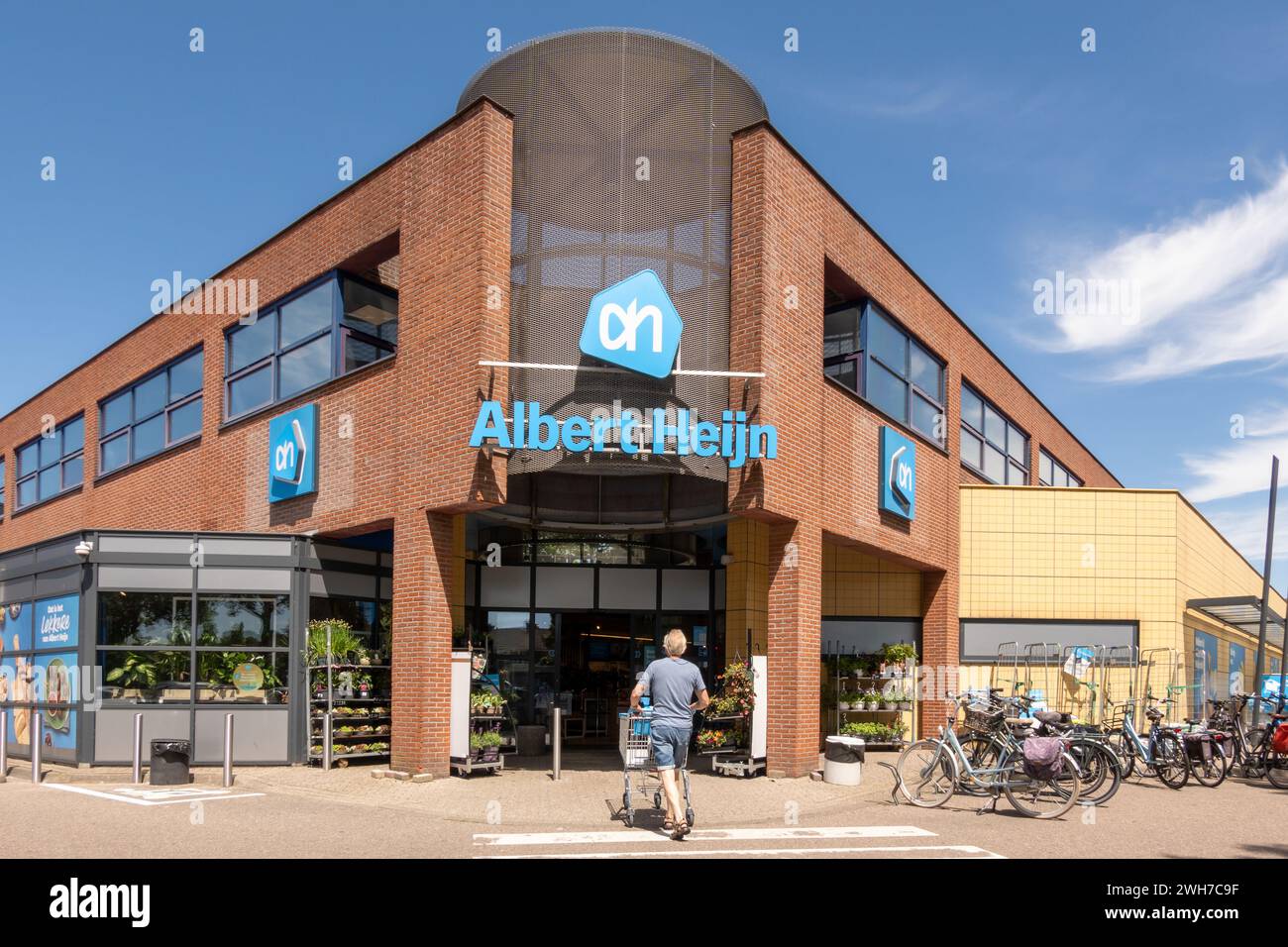 Man with cart goes grocery shopping at Albert Heijn in Medemblik, the leading supermarket chain in Netherlands Stock Photo