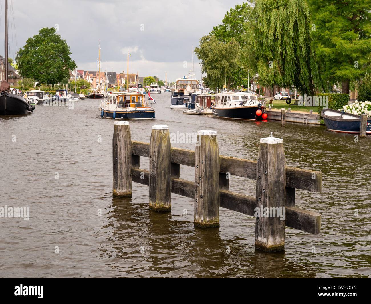 Canal with bollard and boats in old town of Lemmer, Friesland, Netherlands Stock Photo